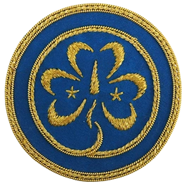 Emblemat Światowego Stowarzyszenia Przewodniczek i Skautek - WAGGGS